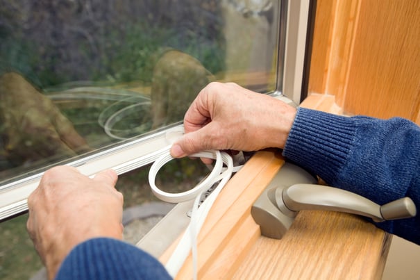 man installing window weathering