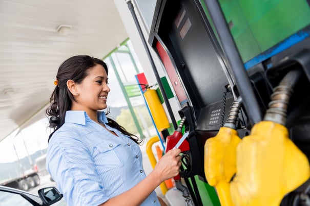 Woman using a gas card at the pump