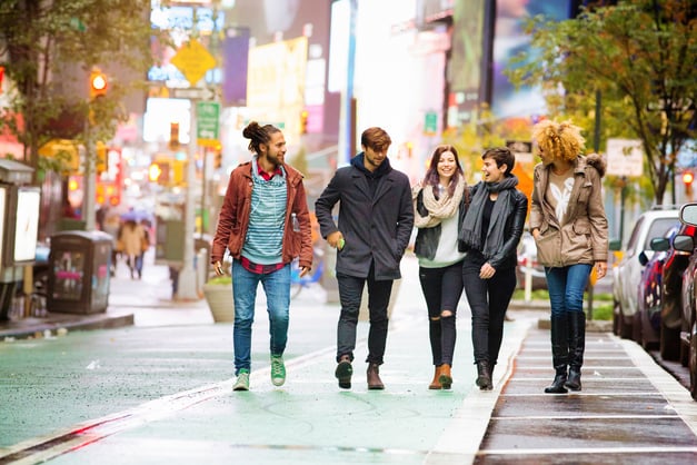 Group of friends walking downtown in a city