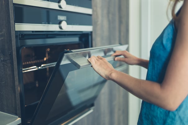 woman opening oven