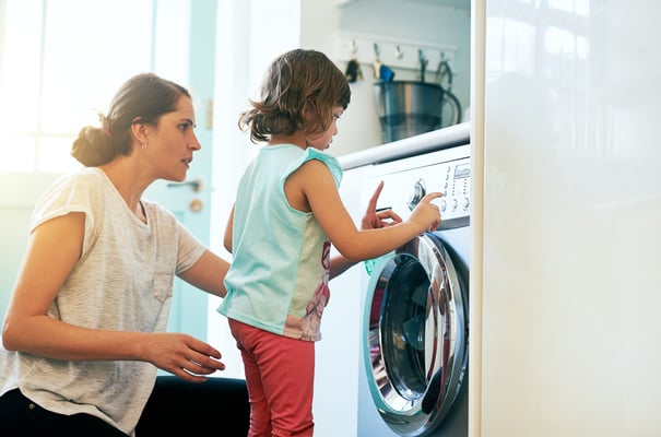 Mom showing daughter how to use dryer