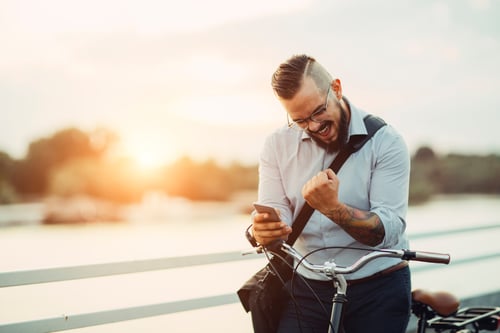 Man with bike and cell phone - GettyImages-482983366