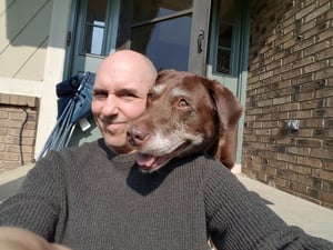 Sr LO Ray Singer and the Chocolate Lab Cocoa Bella — with Ray Singer.