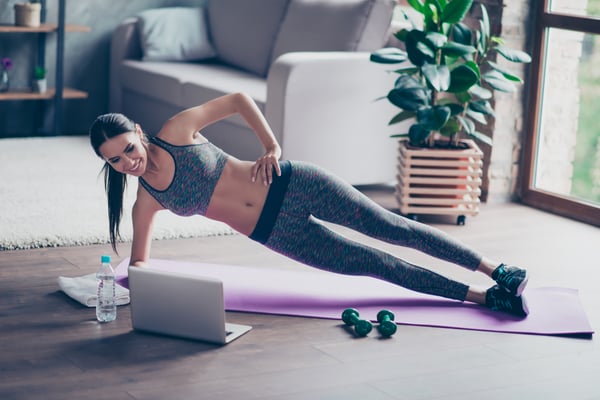 Woman exercising to video on computer