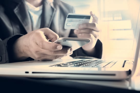 Man using a credit card on laptop