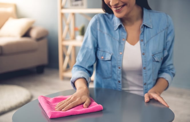 woman cleaning a table