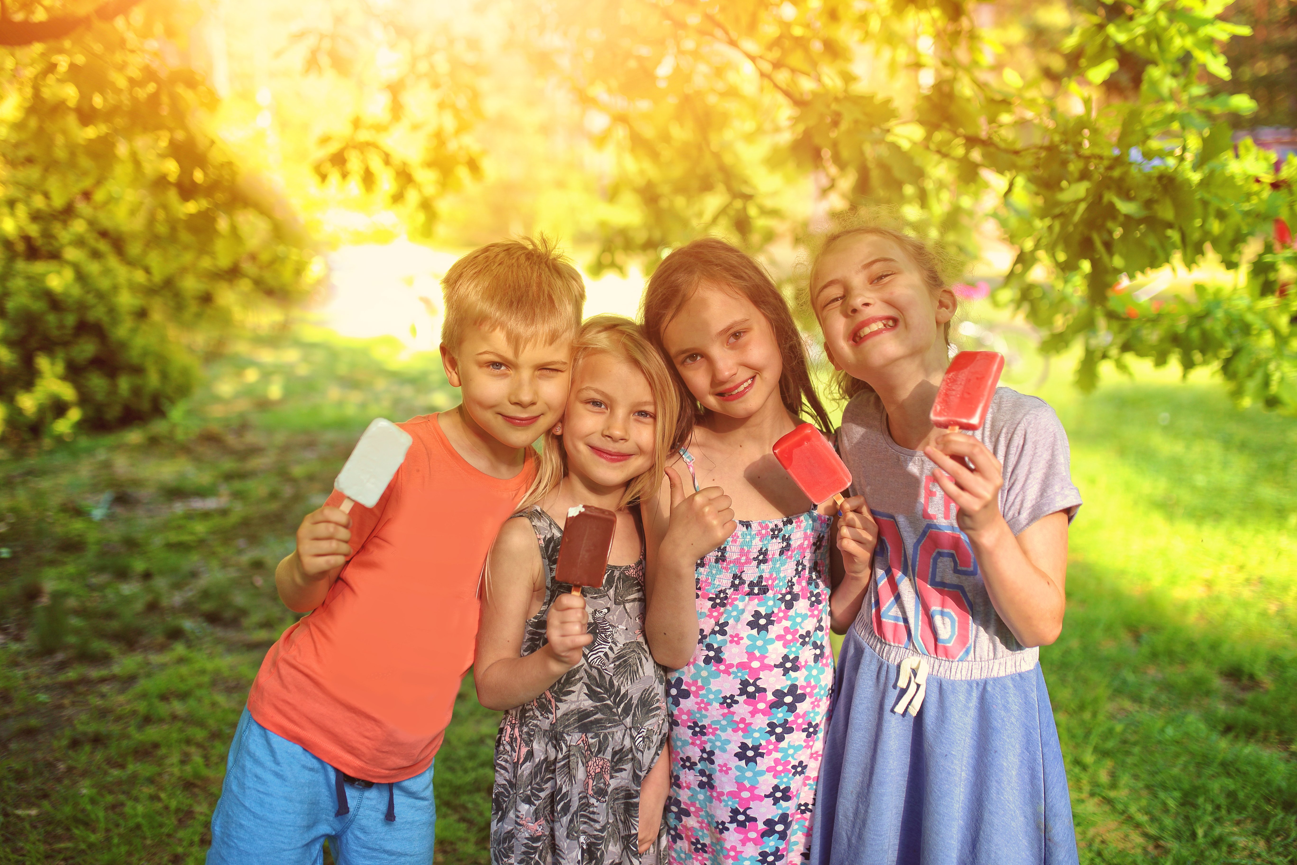 Kids enjoy a popsicle on a warm day.