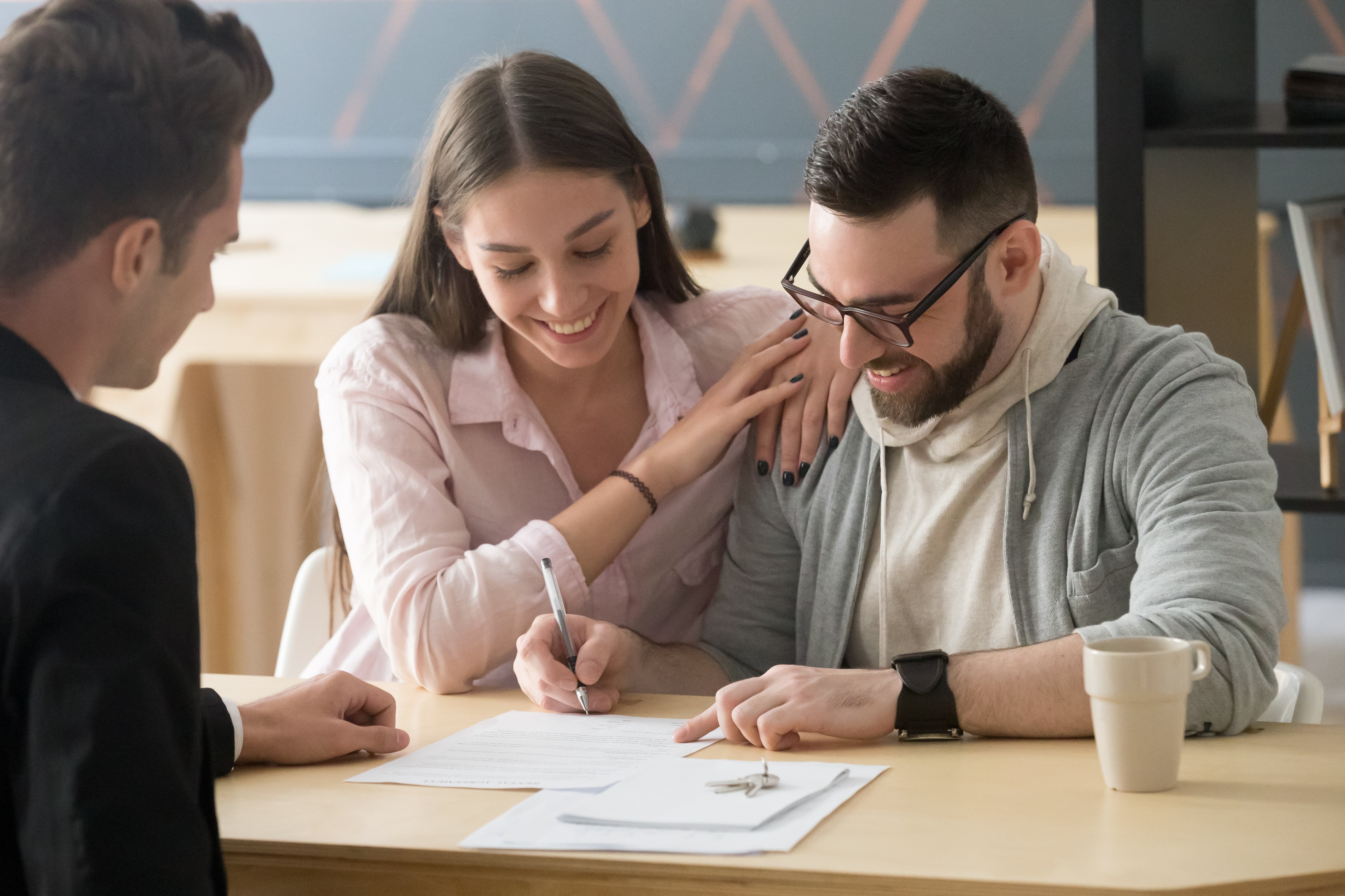 Couple sitting down with loan officer to start the application and documentation stage of the mortgage process