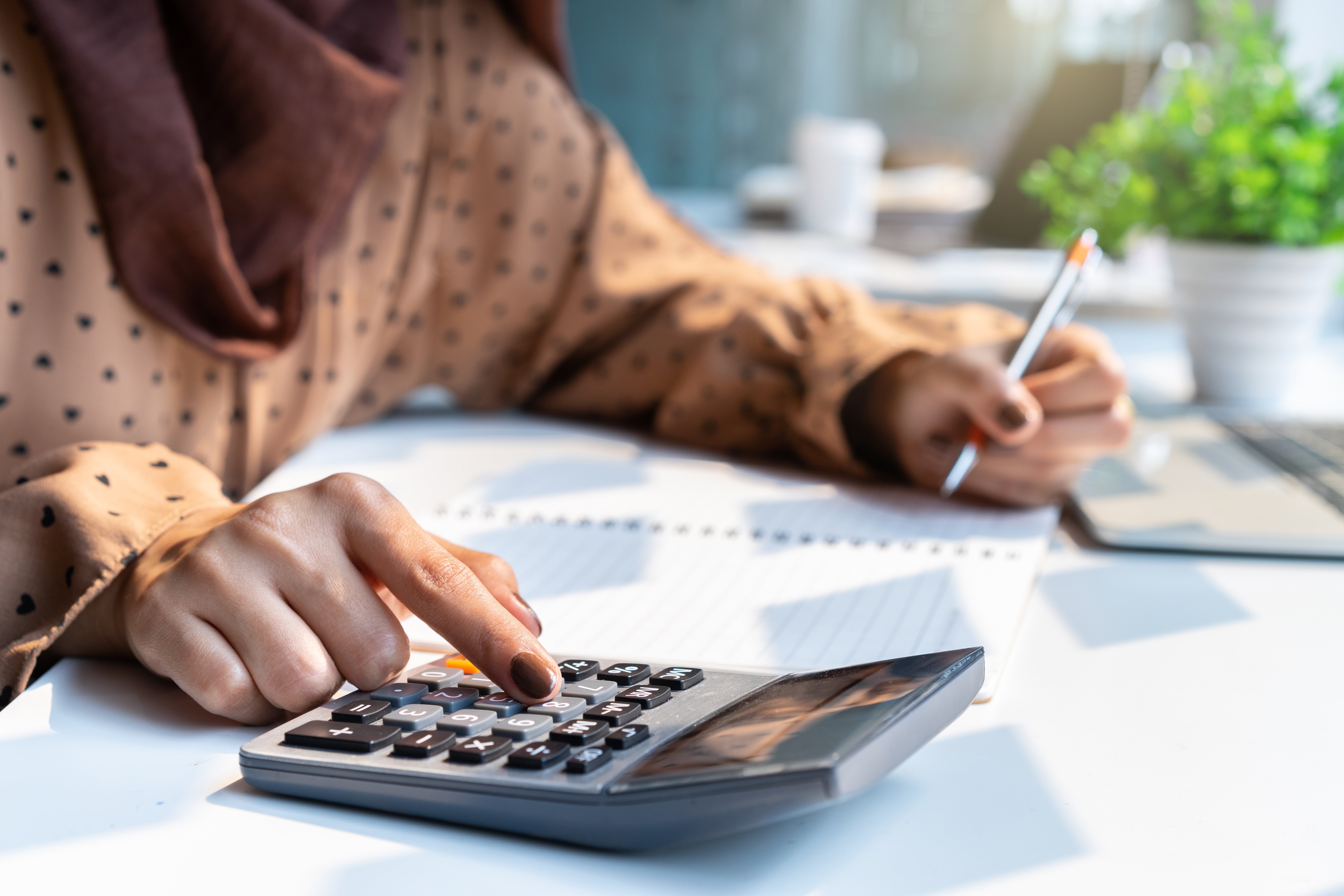 Person using a calculator at a desk