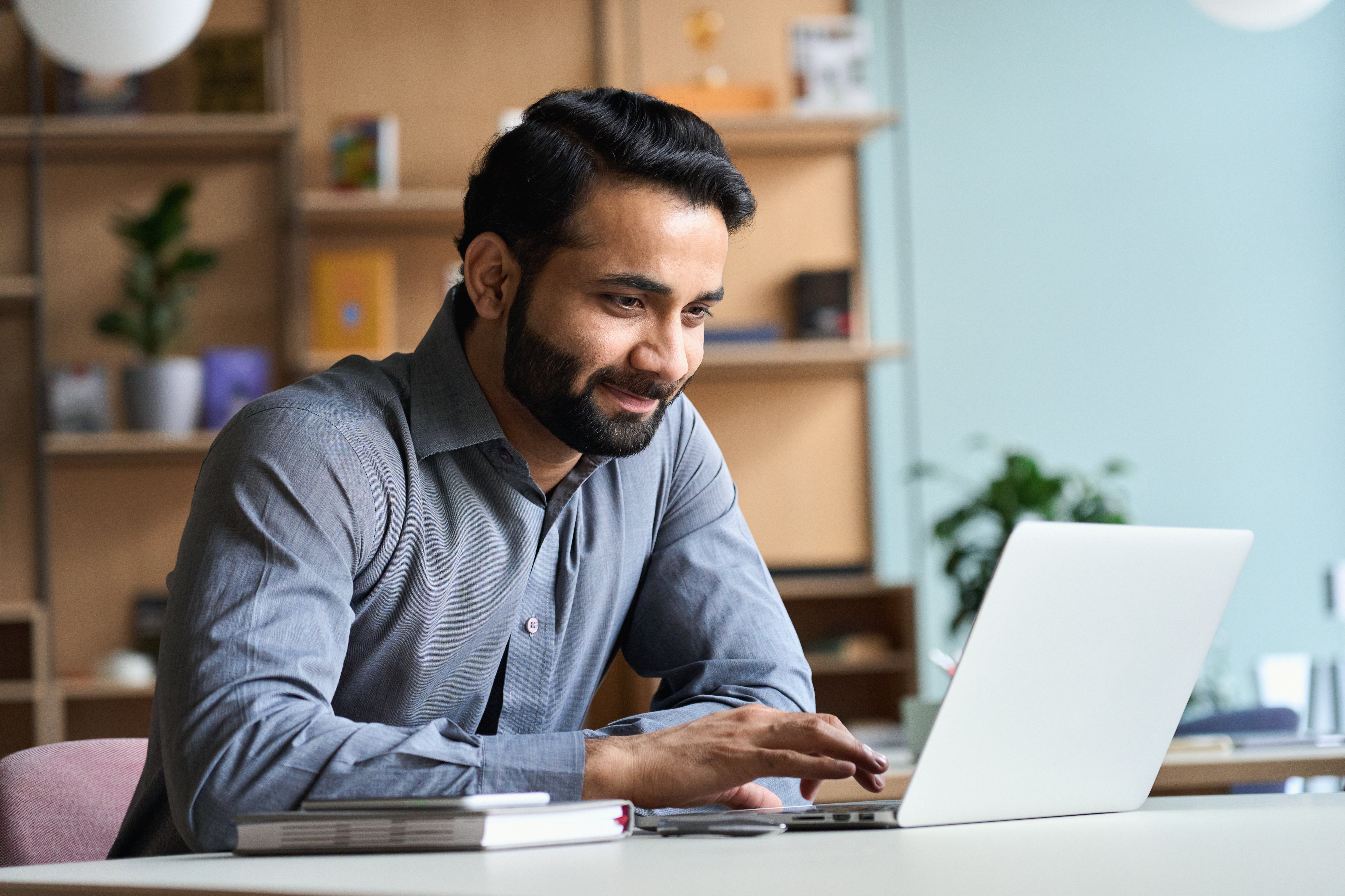 Man at computer applying for pre-approval for mortgage.