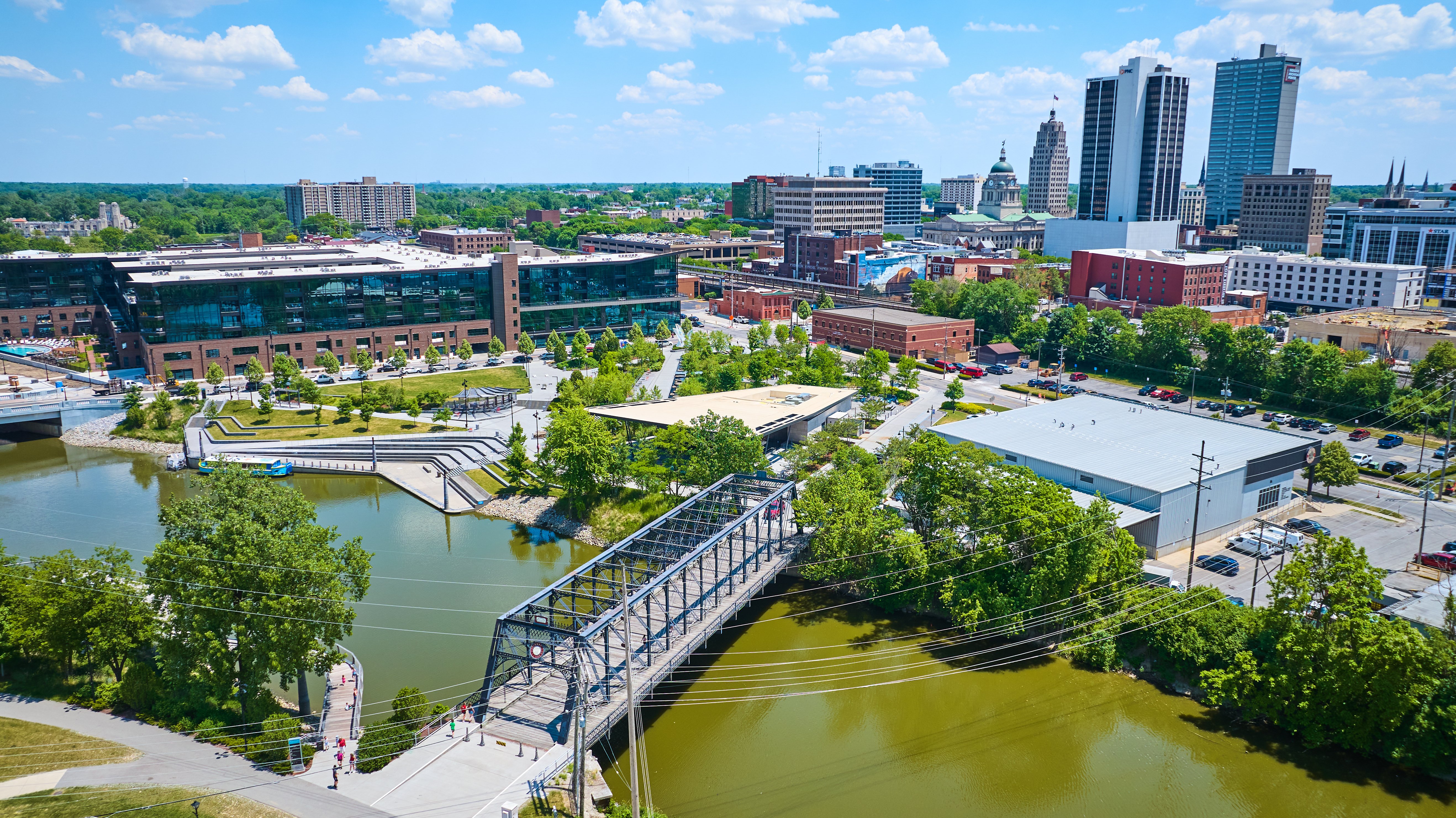 Aerial Wells Street Bridge crossing river into Promenade Park with downtown in background
